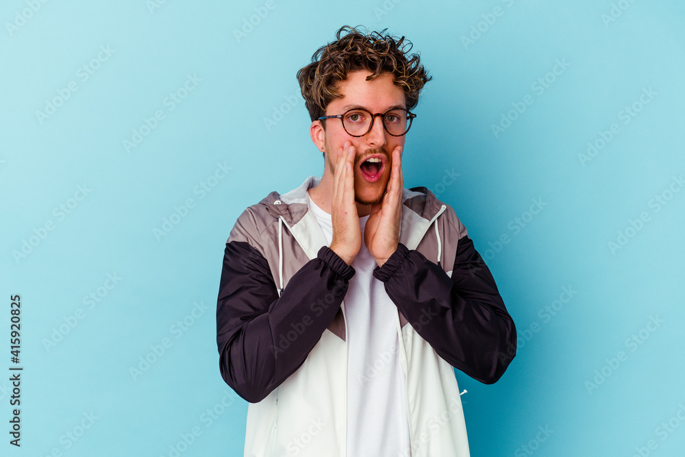 Young caucasian man wearing eyeglasses isolated on blue background scared and afraid. Young caucasian man wearing eyeglasses isolated on blue background scared and afraid.