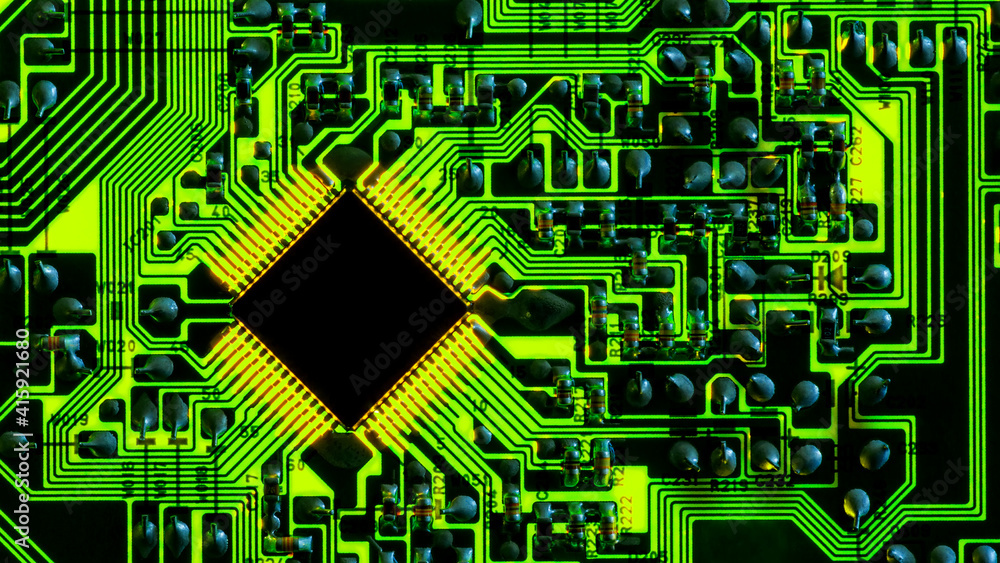 Full-screen texture of green backlit printed circuit board with microchip