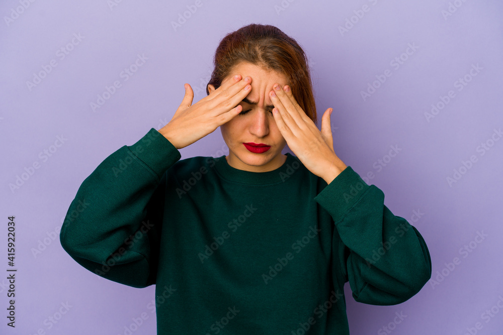 Young arab mixed race woman having a head ache, touching front of the face. Young arab mixed race woman having a head ache, touching front of the face.