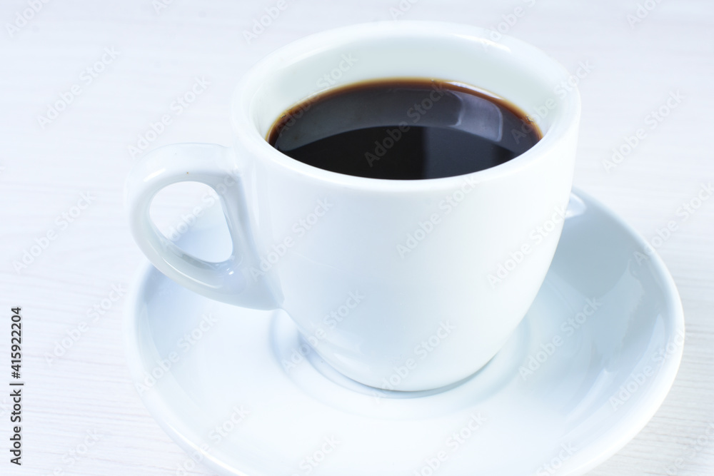 Cup of colombian coffee, decorated on white wooden background Cup of colombian coffee, decorated on white wooden background