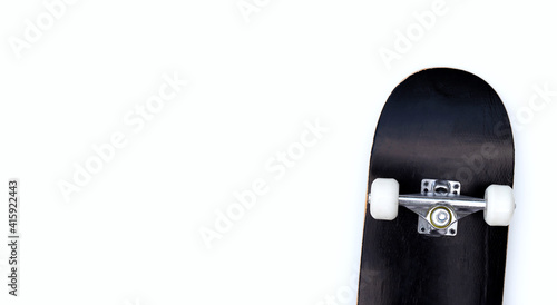 Black skateboard on white background.
