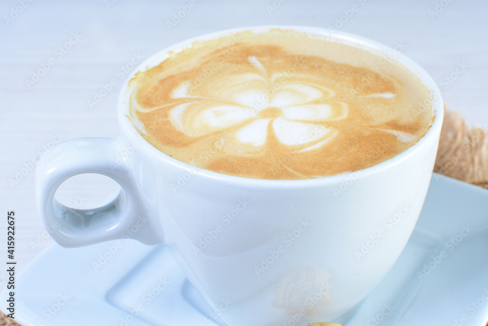 Cup of colombian coffee, decorated on white wooden background