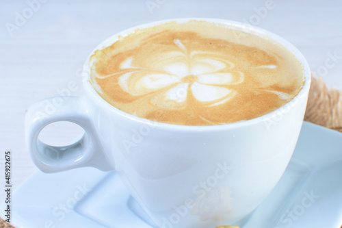 Cup of colombian coffee, decorated on white wooden background