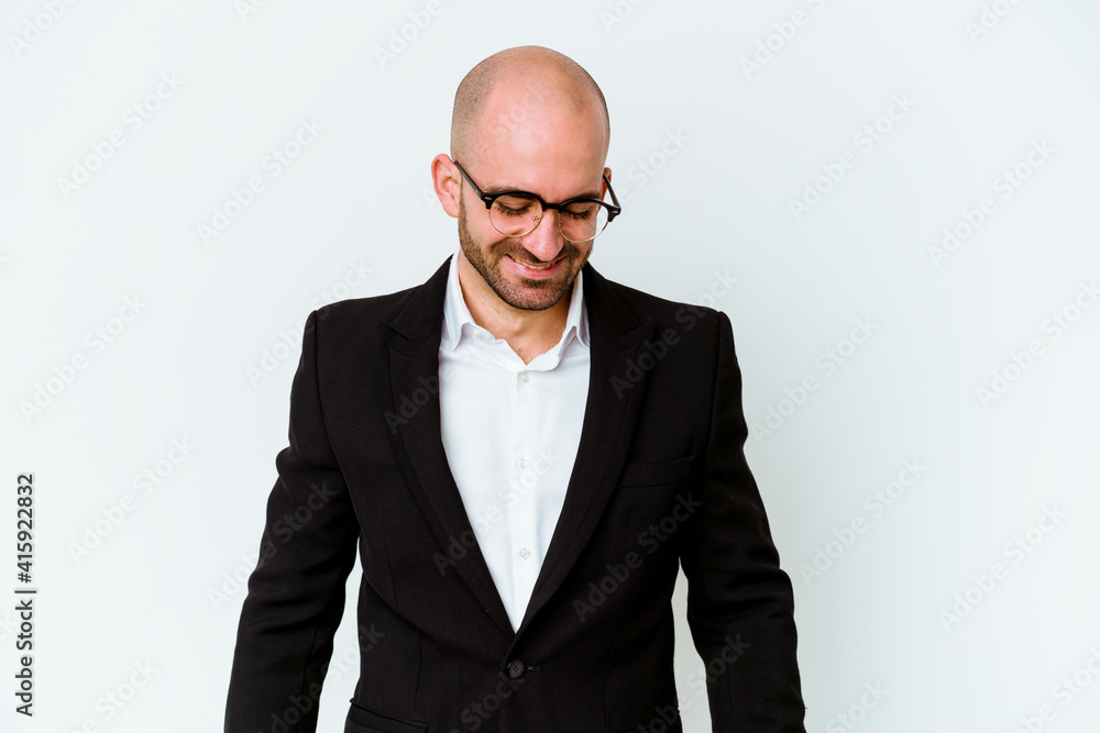 Young business caucasian bald man isolated on blue background laughs and closes eyes, feels relaxed and happy. Young business caucasian bald man isolated on blue background laughs and closes eyes, feels relaxed and happy.