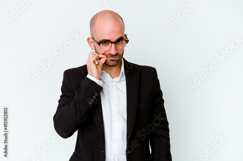 Young business caucasian bald man isolated on blue background with fingers on lips keeping a secret.