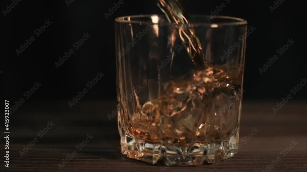 Super Slow Motion Shot of Pouring Whiskey into Glass Super Slow Motion Shot of Pouring Whiskey into Glass