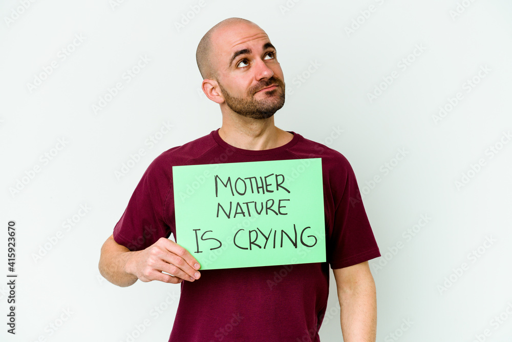 Young caucasian bald man holding a Mother Nature crying isolated on white background dreaming of achieving goals and purposes Young caucasian bald man holding a Mother Nature crying isolated on white background dreaming of achieving goals and purposes