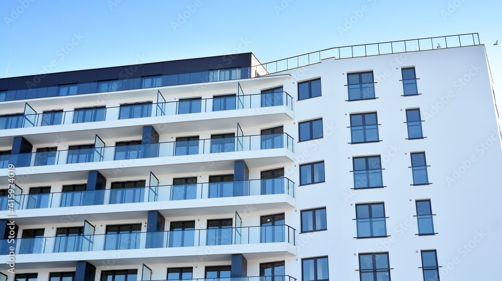 Condominium and apartment building with symmetrical modern architecture in the city downtown. Condominium and apartment building with symmetrical modern architecture in the city downtown.