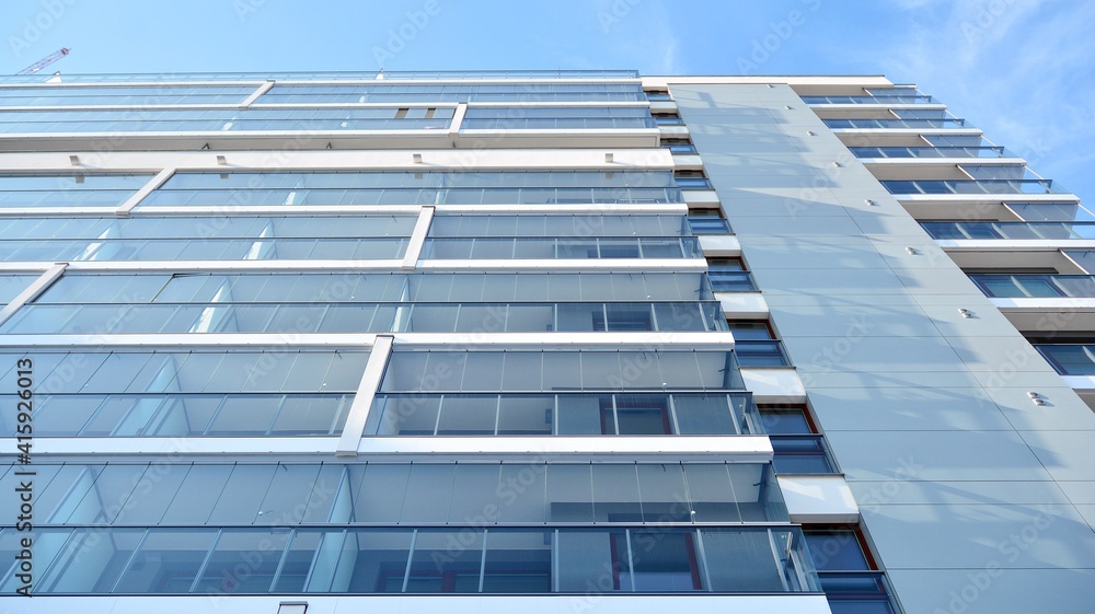 Fototapeta premium Condominium and apartment building with symmetrical modern architecture in the city downtown.