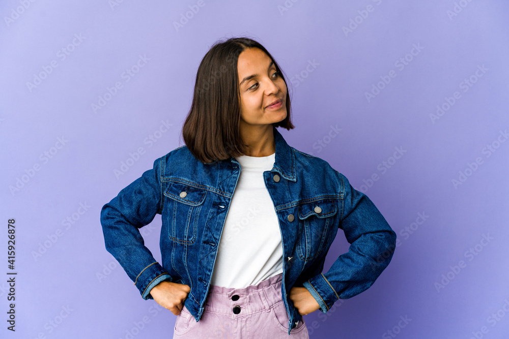 Young mixed race woman laughs happily and has fun keeping hands on stomach. Young mixed race woman laughs happily and has fun keeping hands on stomach.
