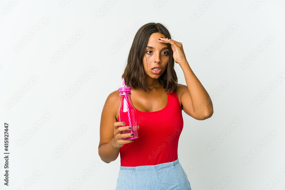 Young latin woman holding a milkshake isolated on white background Young latin woman holding a milkshake isolated on white background