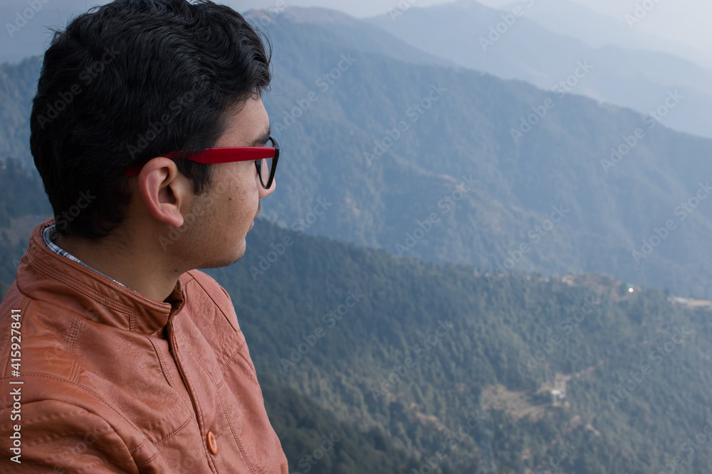 picture of boy looking at beautiful view from top of mountain picture of boy looking at beautiful view from top of mountain