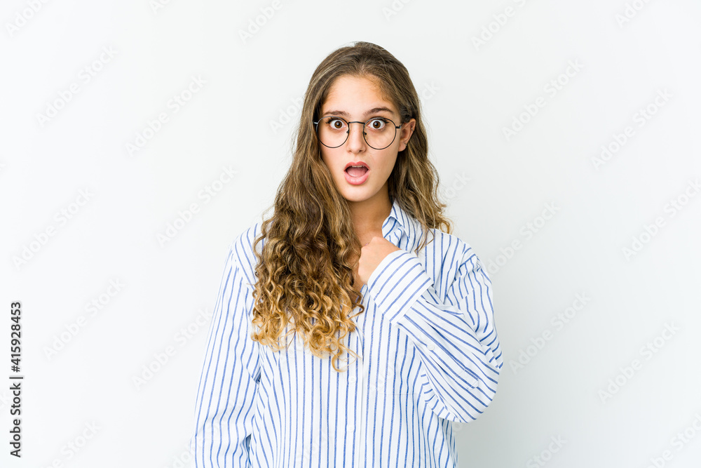 Young caucasian woman surprised pointing with finger, smiling broadly. Young caucasian woman surprised pointing with finger, smiling broadly.