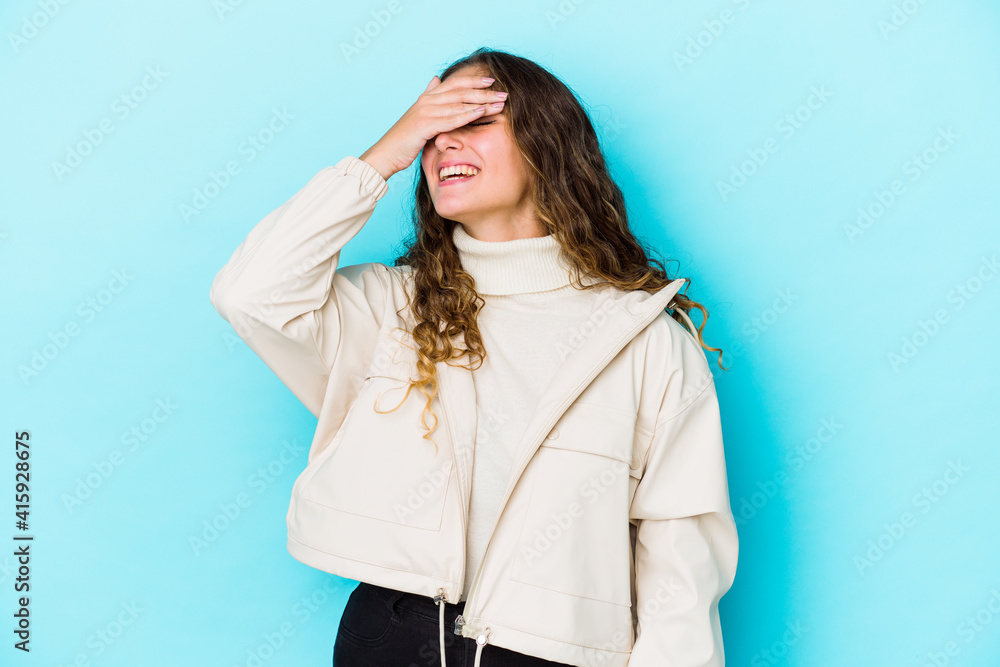 Young caucasian curly hair woman isolated laughs joyfully keeping hands on head. Happiness concept. Young caucasian curly hair woman isolated laughs joyfully keeping hands on head. Happiness concept.