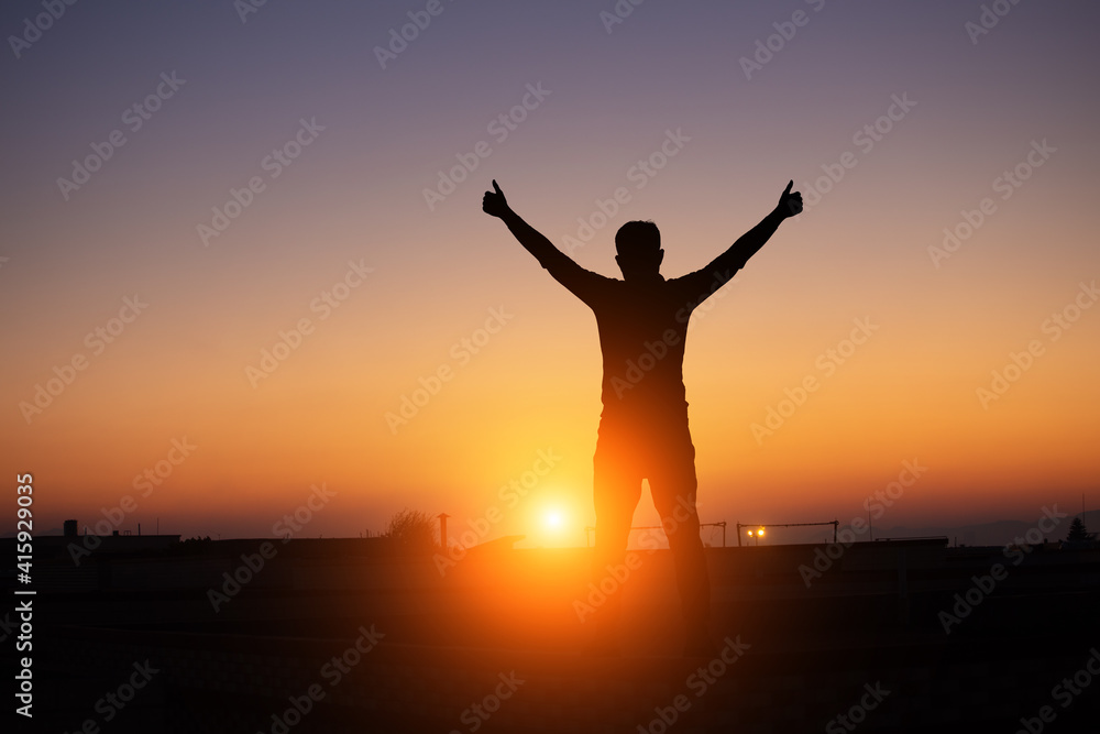 A man embraces the sunrise in the east