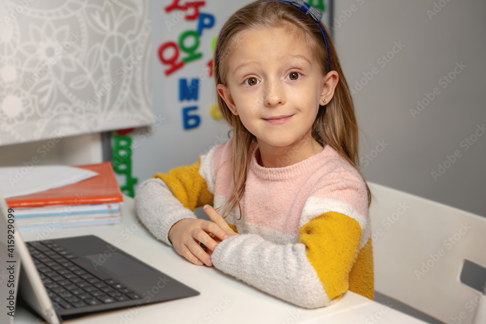 online training. the girl sits at the computer in the room and does her homework online training. the girl sits at the computer in the room and does her homework