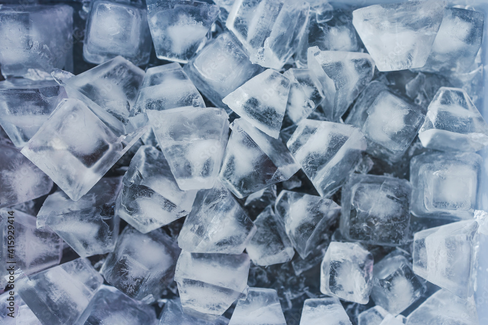 close-up of ice cubes in freezer tray with cold blue tones close-up of ice cubes in freezer tray with cold blue tones