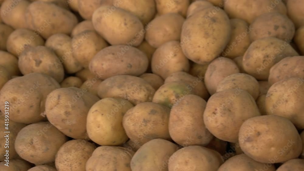 Pile of raw potatoes close up. Organic vegetables on display at farmers market. Healthy food concept. Pile of raw potatoes close up. Organic vegetables on display at farmers market. Healthy food concept.