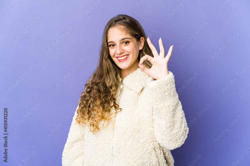 Young caucasian cute woman cheerful and confident showing ok gesture. Young caucasian cute woman cheerful and confident showing ok gesture.