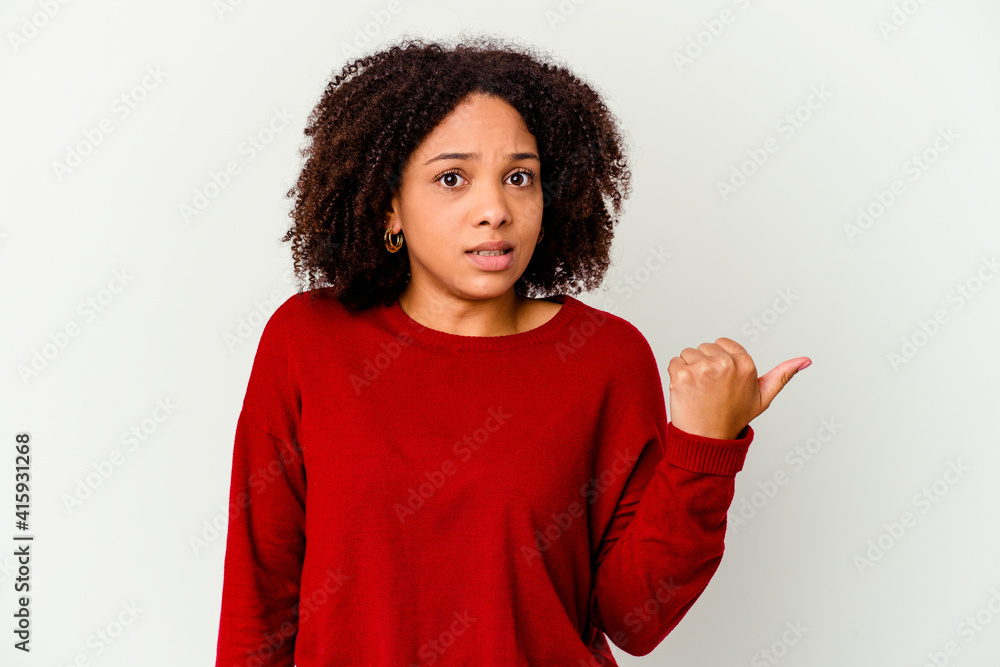 Young african american mixed race woman isolated shocked pointing with index fingers to a copy space. Young african american mixed race woman isolated shocked pointing with index fingers to a copy space.