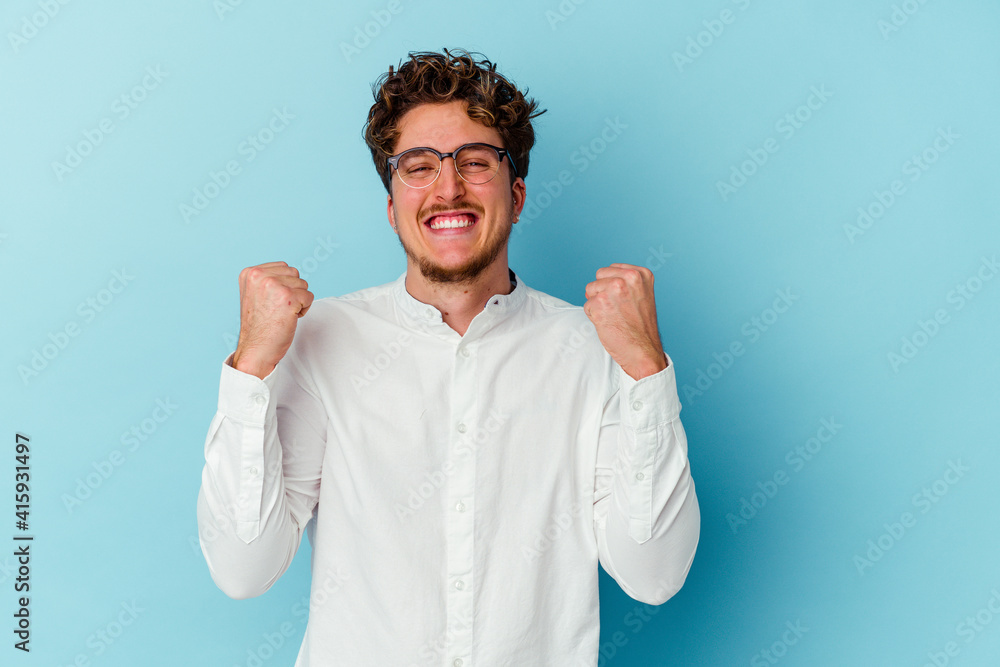Young caucasian business man isolated on blue background cheering carefree and excited. Victory concept. Young caucasian business man isolated on blue background cheering carefree and excited. Victory concept.