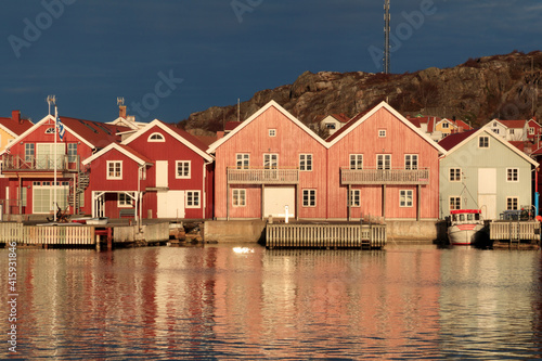 Sweden, Bohuslan, Island of Tjorn. Views over Skarhamn fishing village's rooftops, town and harbor. photo