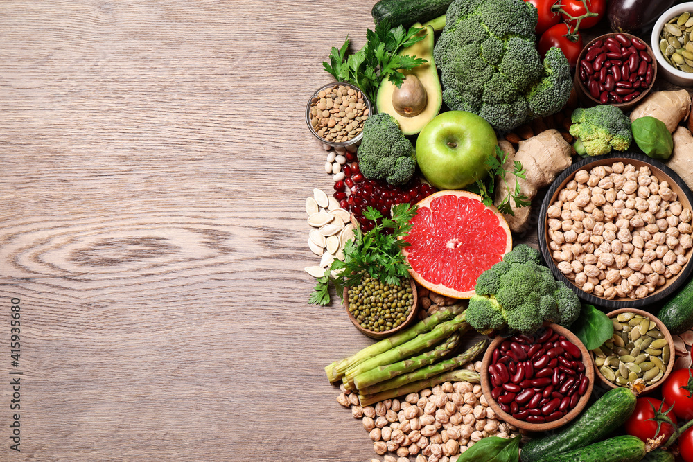 Fresh vegetables, fruits and seeds on wooden table, flat lay. Space for text Fresh vegetables, fruits and seeds on wooden table, flat lay. Space for text