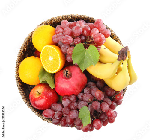 Fototapeta Naklejka Na Ścianę i Meble -  Wicker basket with different fruits on white background, top view