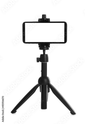 Smartphone with blank screen fixed to tripod on white background, mockup for design photo
