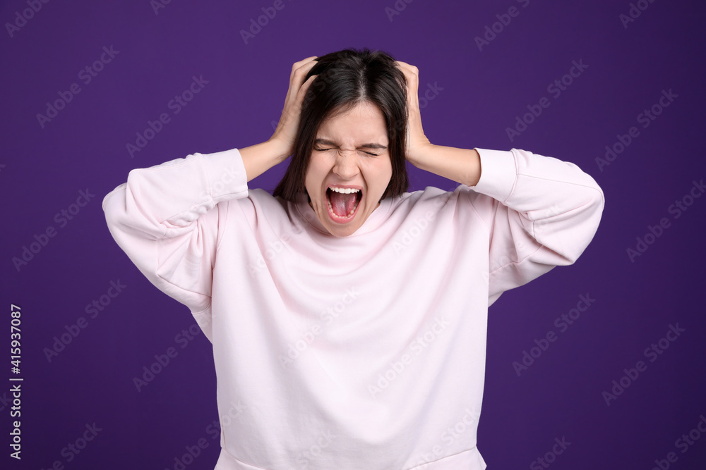 Portrait of stressed young woman on purple background Portrait of stressed young woman on purple background