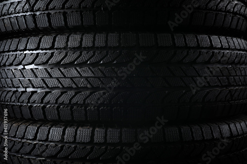 Stacked winter tires as background, closeup. Car maintenance © New Africa