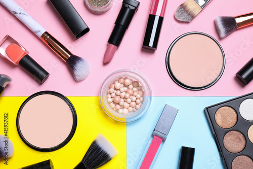 Different luxury makeup products on color background, flat lay