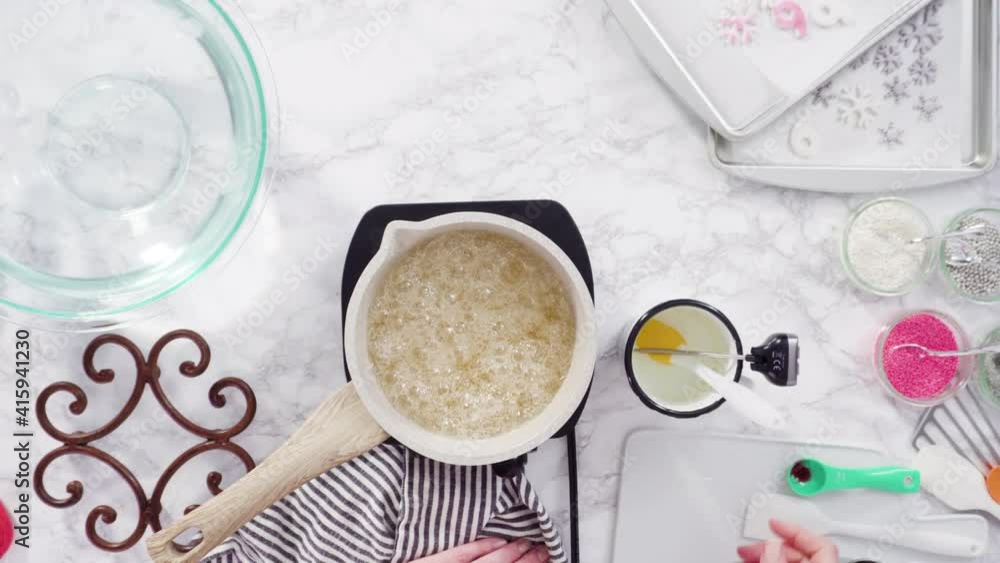 Flat lay. Step by step. Caramelizing sugar in a small cooking pot over the small electric stove. Flat lay. Step by step. Caramelizing sugar in a small cooking pot over the small electric stove.