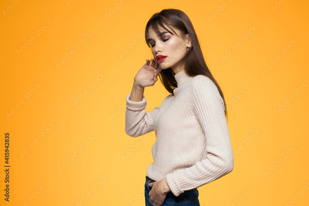 Cute brunette makeup red lips fashionable clothes yellow background Cute brunette makeup red lips fashionable clothes yellow background