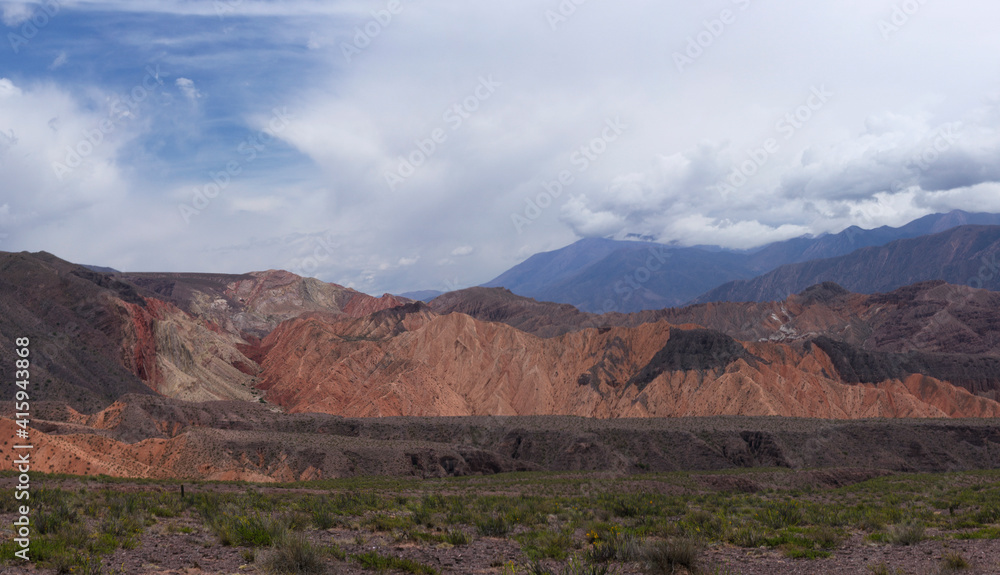 The Andes mountain range. Panorama view of the valley and colorful mountains under a beautiful sky.	