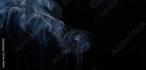 Burning incense, white smoke, black background, used as a worship background image, a sacred object of Buddhist beliefs, focus on the smoke.