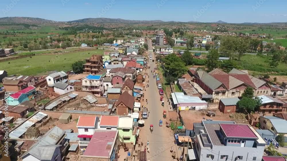 Aerial view of traffic and colorful houses along the main road in a town in rural area Aerial view of traffic and colorful houses along the main road in a town in rural area