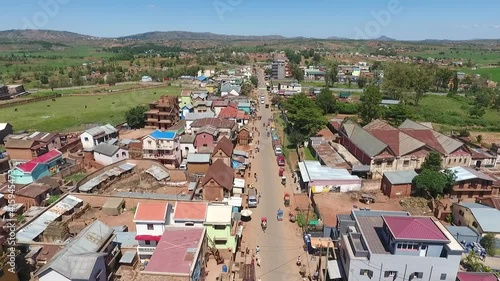 Aerial view of traffic and colorful houses along the main road in a town in rural area photo