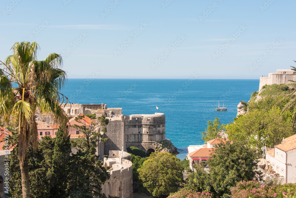 Croatia, Dubrovnik. Fort Bokar Pile Gate defense walled city. Sailboat on Adriatic Sea.