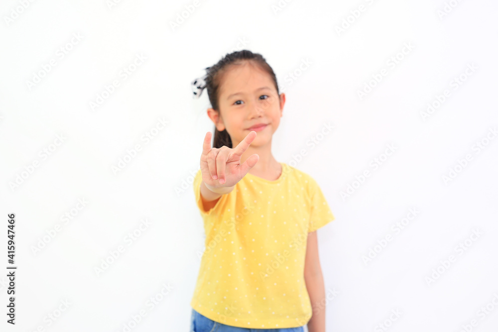Asian little girl show finger I love you symbol sign language on white isolated background. Focus at his finger. Asian little girl show finger I love you symbol sign language on white isolated background. Focus at his finger.