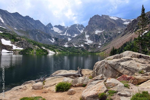 Fototapeta Naklejka Na Ścianę i Meble -  magnificent arapahoe, navajo, and shoshoni peaks with a mountain stream and snowfield on a sunny summer day along the lake isabele trail in the indian peaks wilderness area near nederland, colorado