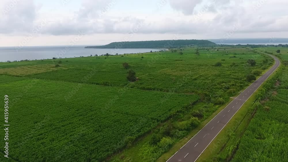 aerial landscape of samota rural village in sumbawa island, farm corn field land with seascape view over the arcipelago during a cloudy day aerial landscape of samota rural village in sumbawa island, farm corn field land with seascape view over the arcipelago during a cloudy day