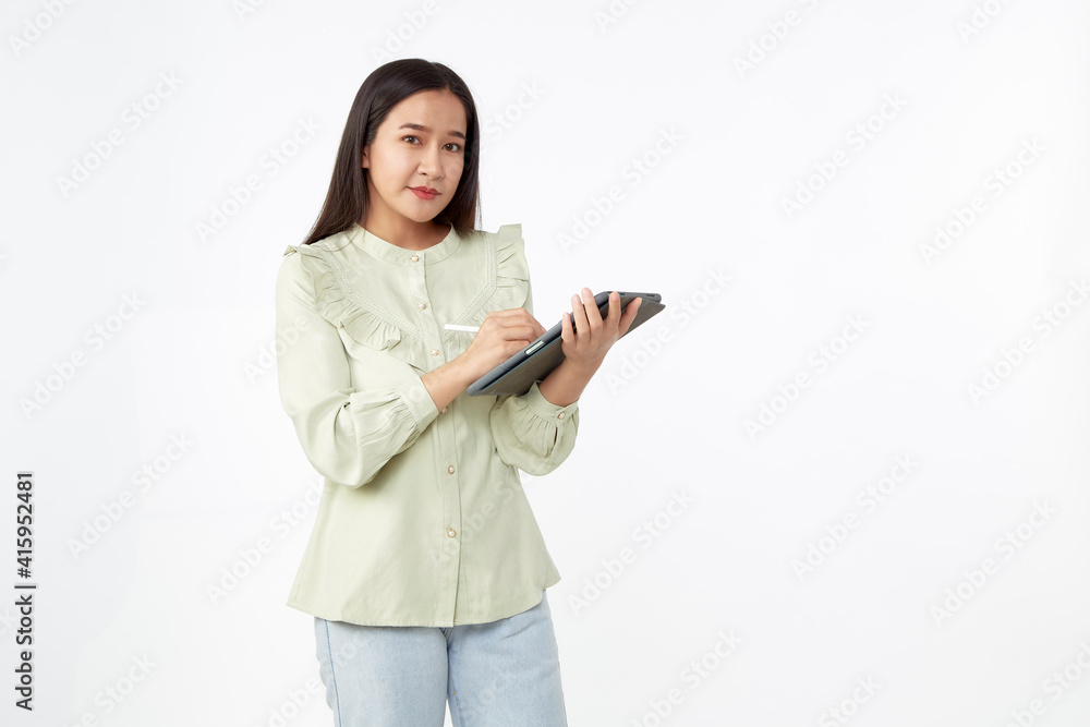 Beautiful young woman holding digital tablet and looking at camera with smile while standing. Wireless technology. Beautiful young woman holding digital tablet and looking at camera with smile while standing. Wireless technology.