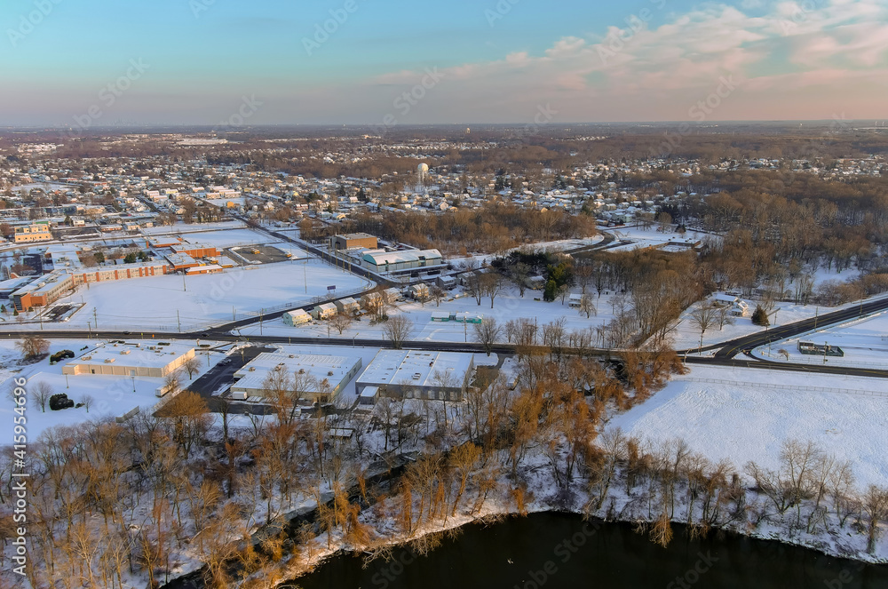Residential houses areas in snowy covered neighborhood district City of Burlington, NJ with by the Delaware river with panorama of winter landscape