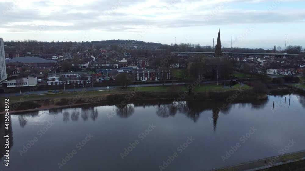 Runcorn old town waterfront aerial low push in view suburban residential property housing and church spire district Runcorn old town waterfront aerial low push in view suburban residential property housing and church spire district