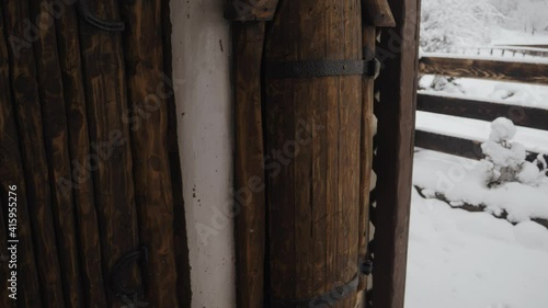 Close Up Details Of Wooden Door And Column With Snowy Landscape In Background. photo