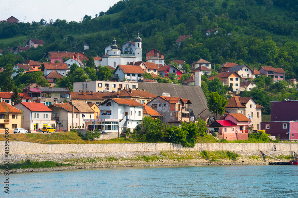 Houses and Virgin Mary Church on the riverbank of the Drina River, Visegrad, Bosnia and Herzegovina
