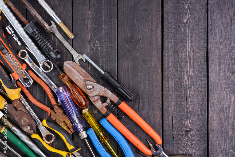 Hand tools and equipment are placed on the wooden floor with copy space for designing text - top view Hand tools and equipment are placed on the wooden floor with copy space for designing text - top view