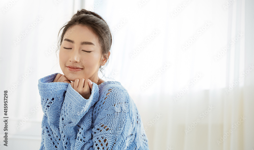 Portrait of beautiful asian woman relax face in winter bedroom. Closeup sexy beauty fashion girl healthy makeup facial treatment perfect glow skin. Smile happy hygge asia korean girl in blue sweater Portrait of beautiful asian woman relax face in winter bedroom. Closeup sexy beauty fashion girl healthy makeup facial treatment perfect glow skin. Smile happy hygge asia korean girl in blue sweater