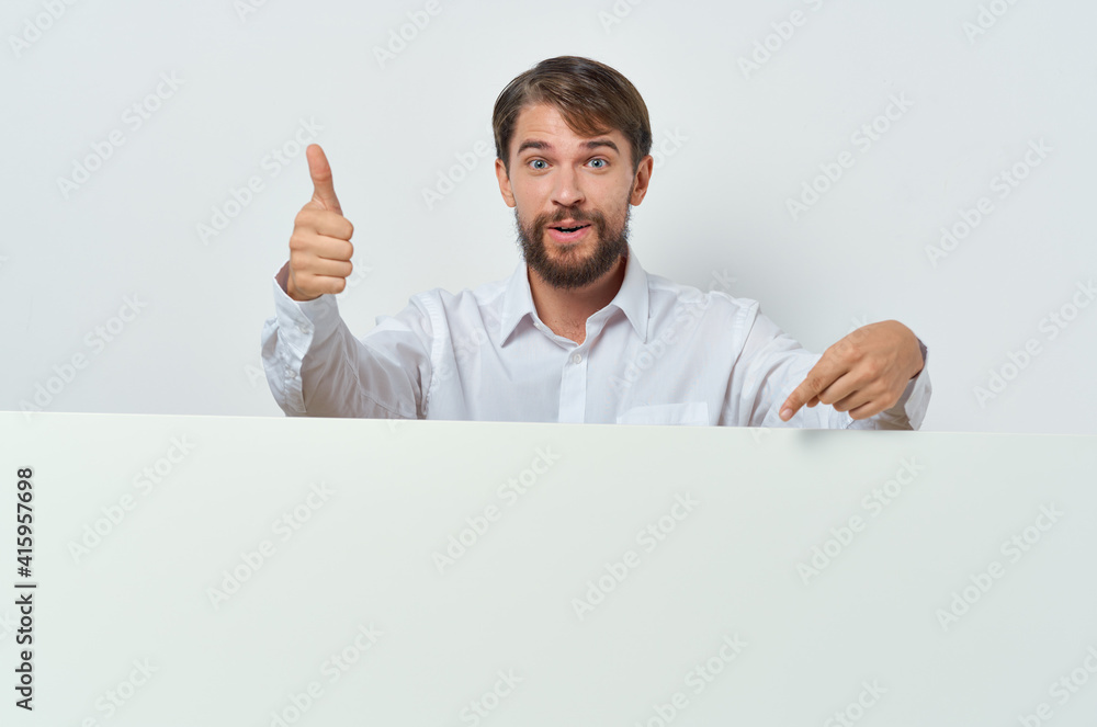 man peeking out from behind banner advertising lifestyle light background man peeking out from behind banner advertising lifestyle light background